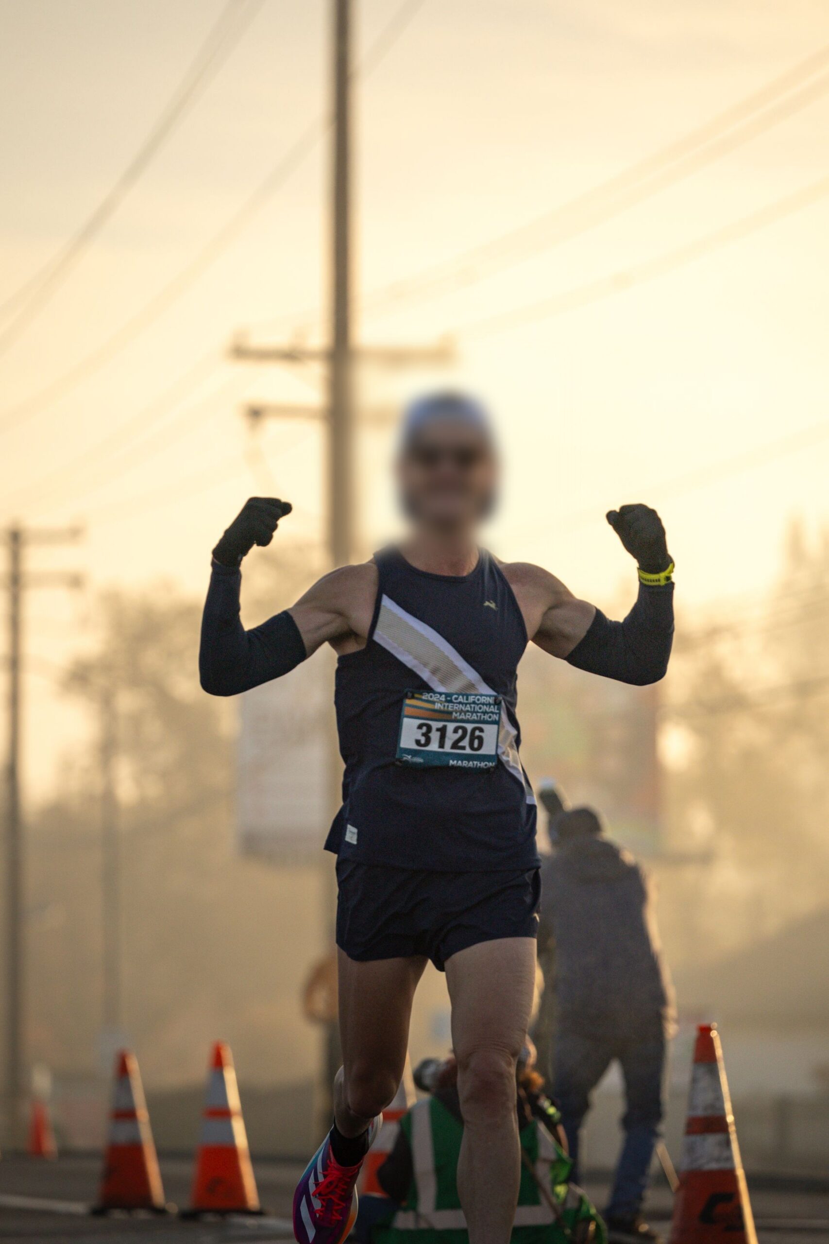 Runner pushing forward toward the finish line, representing running toward your goals